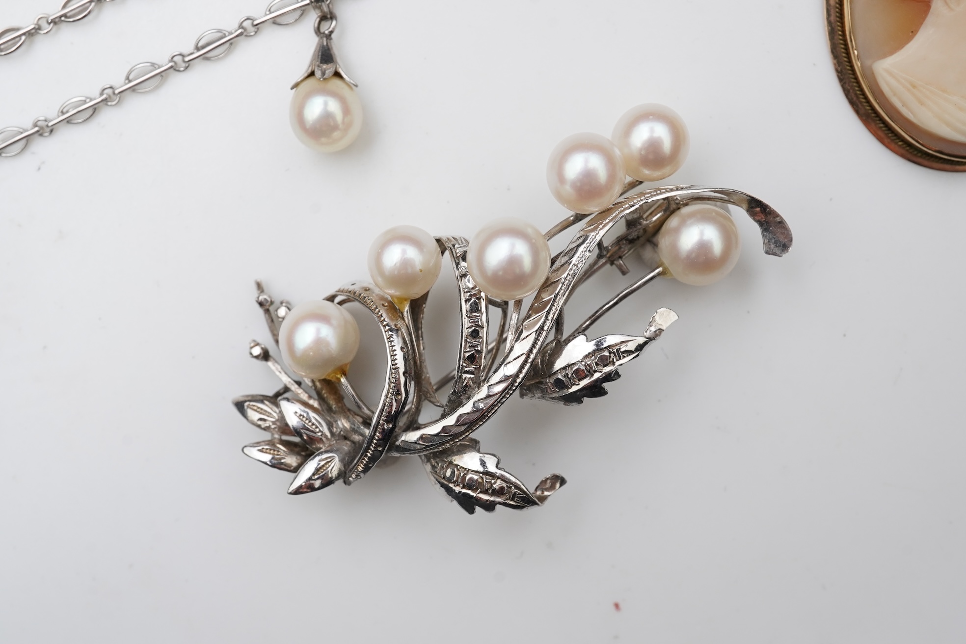 A collection of cultured pearl jewels and a cameo pendant